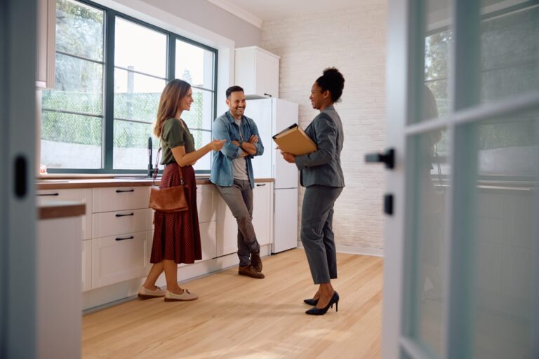 Northwood Wrexham agent talking to homeowners in their kitchen about selling their property