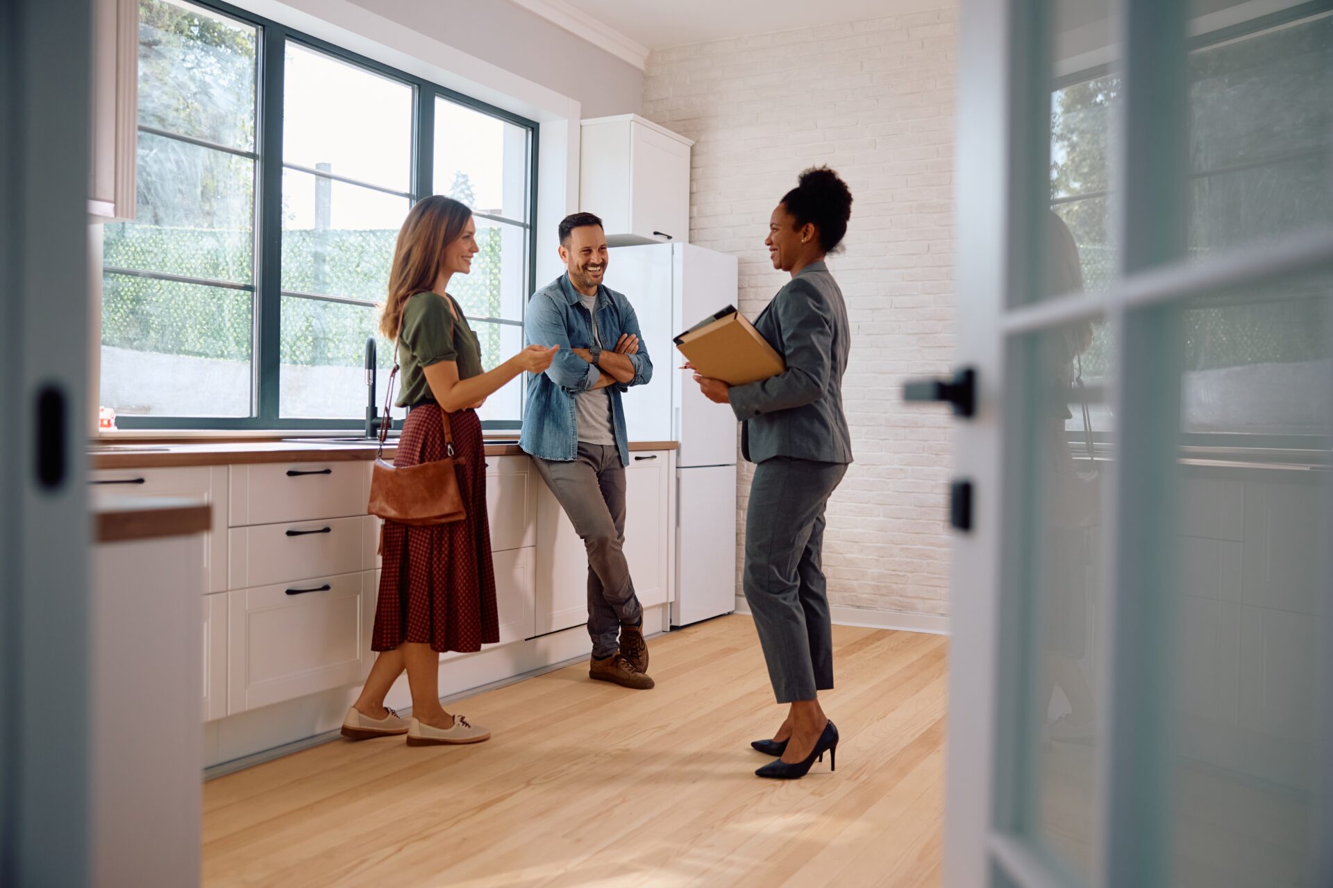 Northwood Wrexham agent talking to homeowners in their kitchen about selling their property