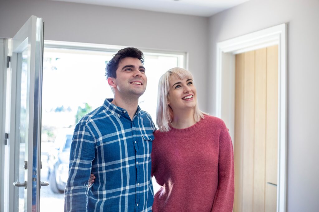 Young couple looking around their new home.