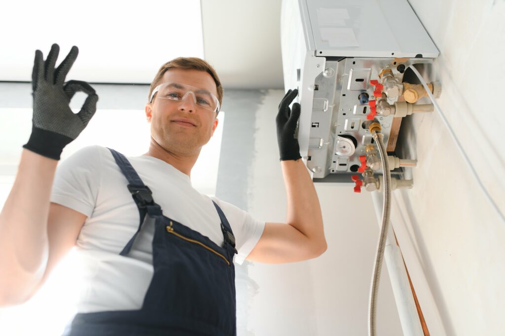 Professional boiler service: qualified technician checking a natural gas boiler at home